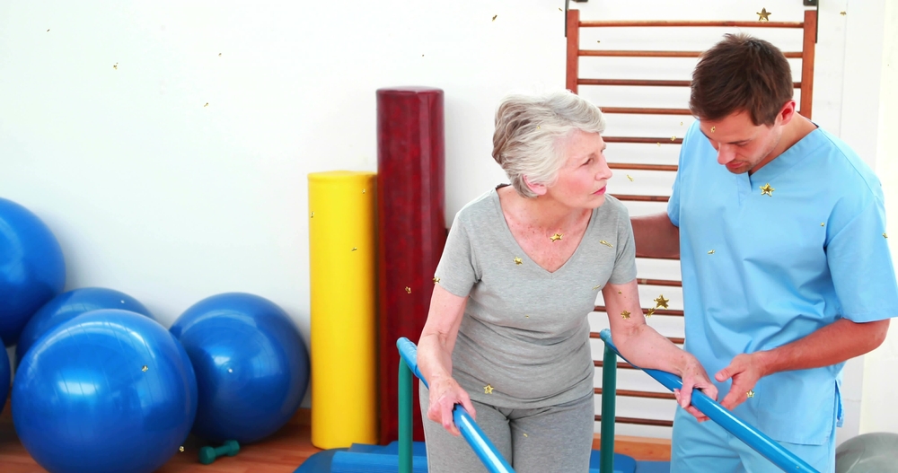 Patient practicing gait training on rehabilitation parallel bars