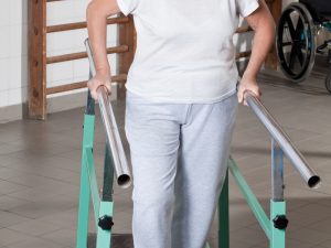 Portrait,Of,Mature,Man,Having,Ambulatory,Therapy. Patient receiving ambulatory therapy in a rehabilitation clinic