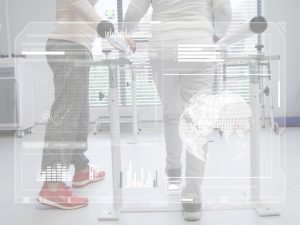 Walking,Patient,Wearing,Red,Sneakers,Supported,By,Therapist,In,Clinic Patient walking with support during rehabilitation